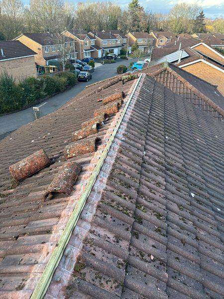 Ridge tiles lifted off and the old bedding exposed