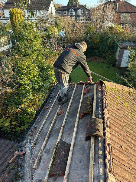 Lifting the old tiles off, torn felt and battens showing behind