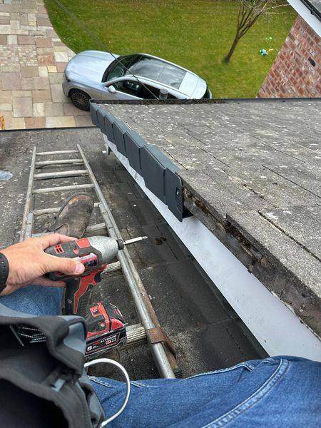 Screwing a cap into the batten end, bare tile edge ahead