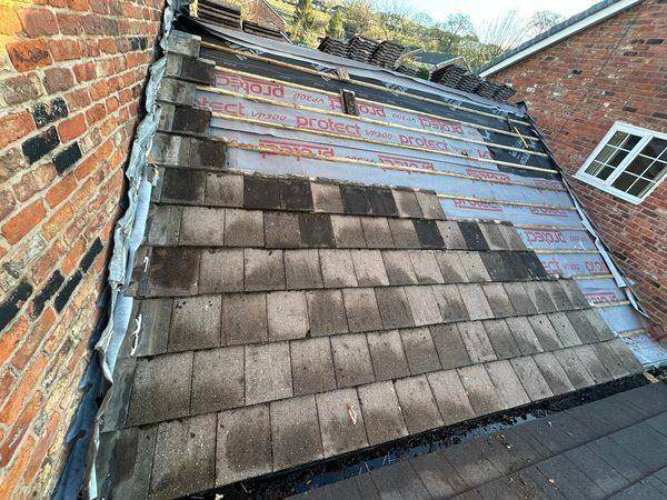 Lower courses relaid over the new underlay, lead dressed at the wall