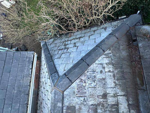 New grey capping closing the hip mitre at the top of the roof