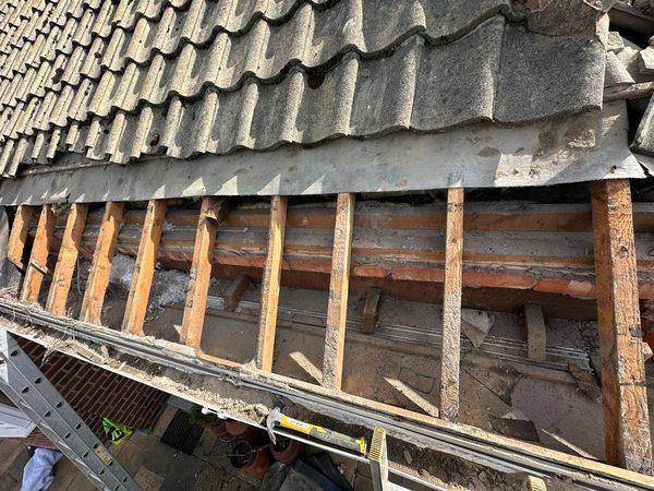 Bottom courses lifted to reach the rafters and old battens