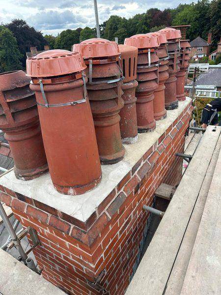 Rebuilt brickwork, new capping and vented cowls on every pot